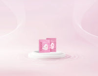 Two Quasi Collagen Glow Up Mask 2.0 boxes on a pale pink podium
