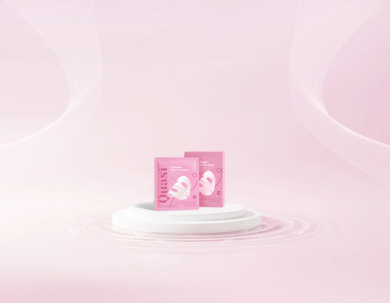 Two Quasi Collagen Glow Up Mask 2.0 boxes on a pale pink podium