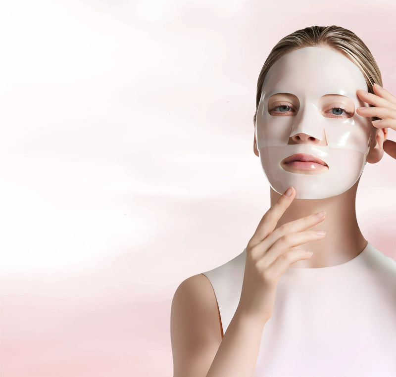 Two Quasi Collagen Glow Up Mask 2.0 boxes on a pale pink podium