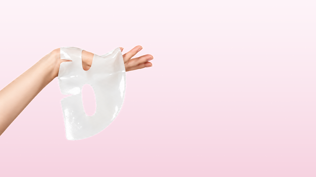The two-piece hydrogel mask held up against a soft pink backdrop